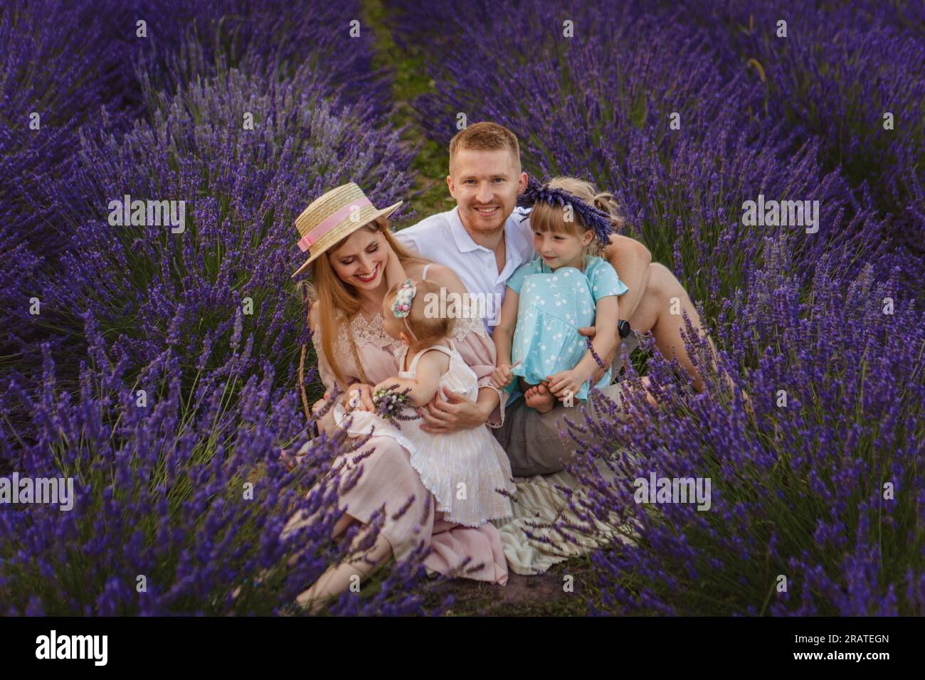 Happy family, father and mother with two daughters on a picnic at lavender field Stock Photo