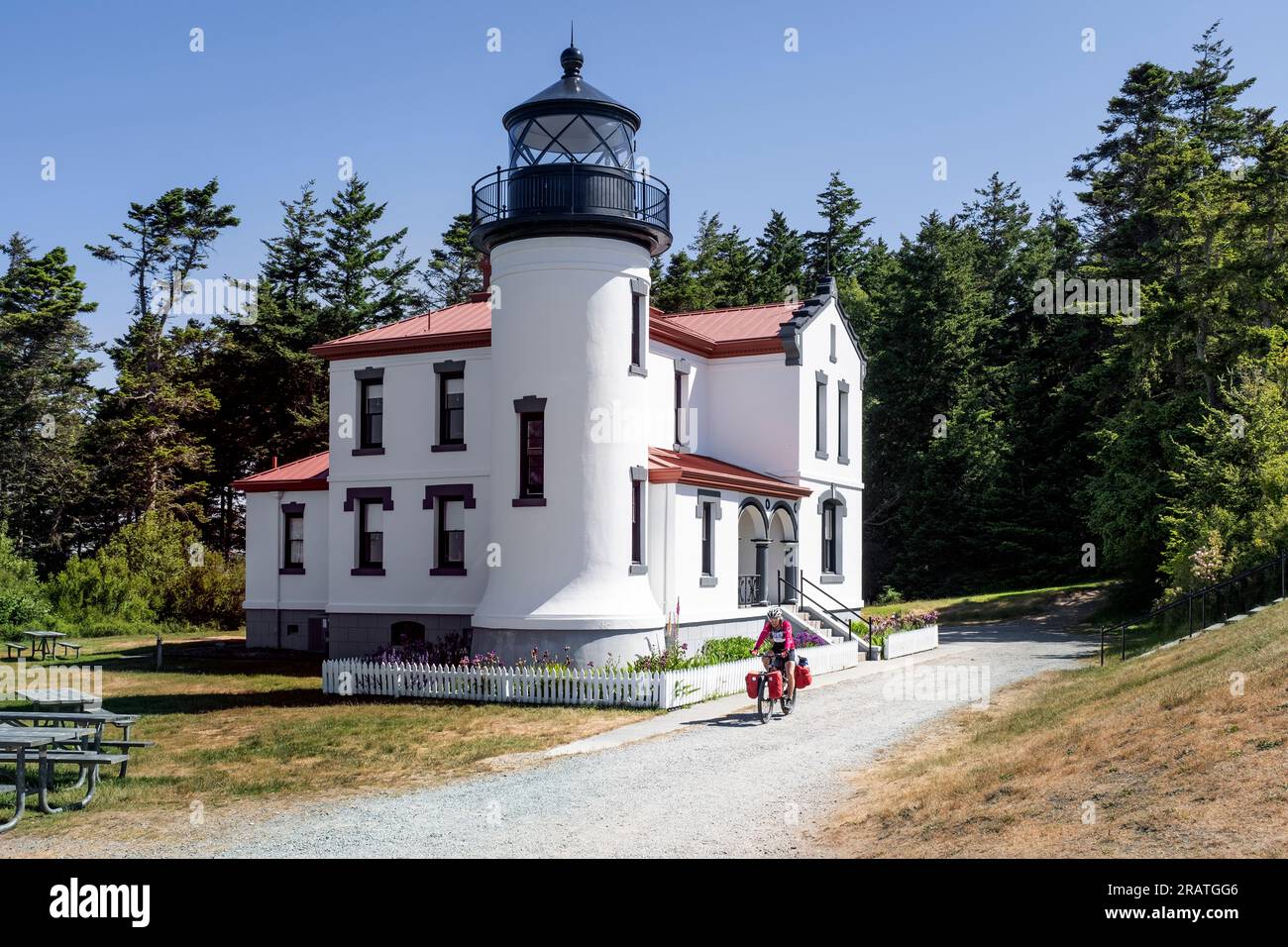 WA24510-00.....WASHINGTON -  Bicyclest tourist at Admiralty Head Lighthouse inFort Casey Historical Park, Whidby Island. Stock Photo