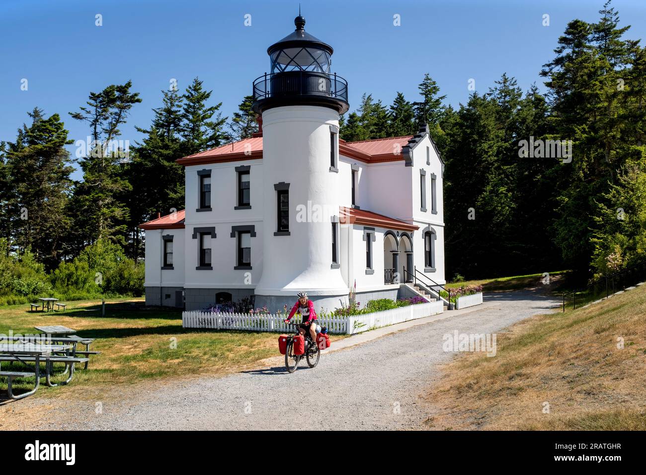 WA24510-00.....WASHINGTON -  Bicycle tourist at Admiralty Head Lighthouse inFort Casey Historical Park, Whidby Island. Stock Photo