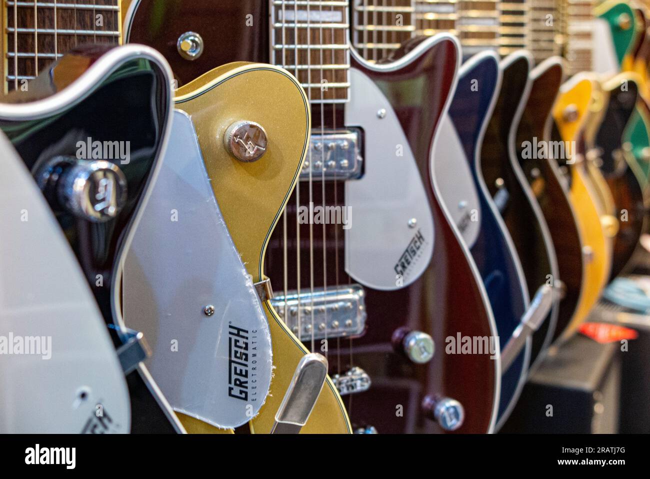 Rows of guitars in a guitar shop Stock Photo