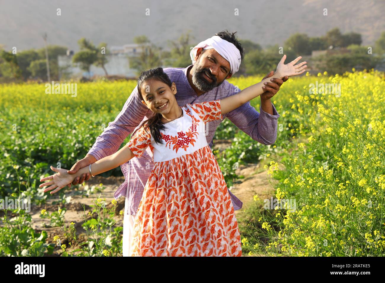 Indian rural happy farmers. Father and daughter in mustard field ...