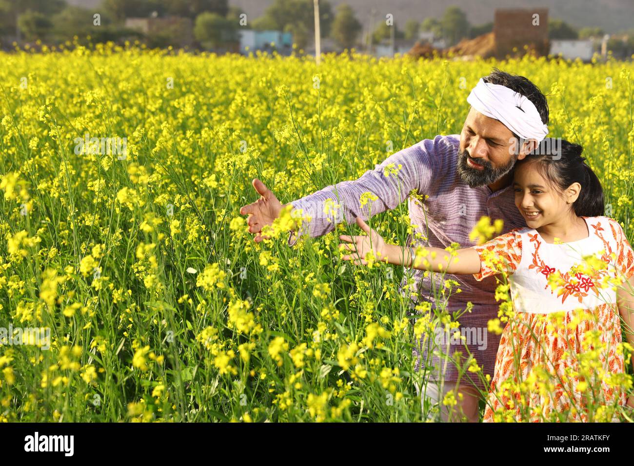 Indian rural happy farmers. Father and daughter in mustard field