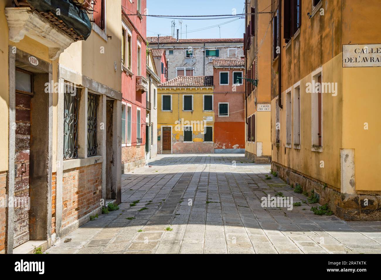 Scene with the narrow streets and the old medieval red brick buiuldings in Venice, Italy. Stock Photo