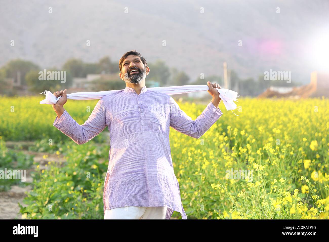 Portrait of Happy Indian farmer feeling the wind while standing in ...