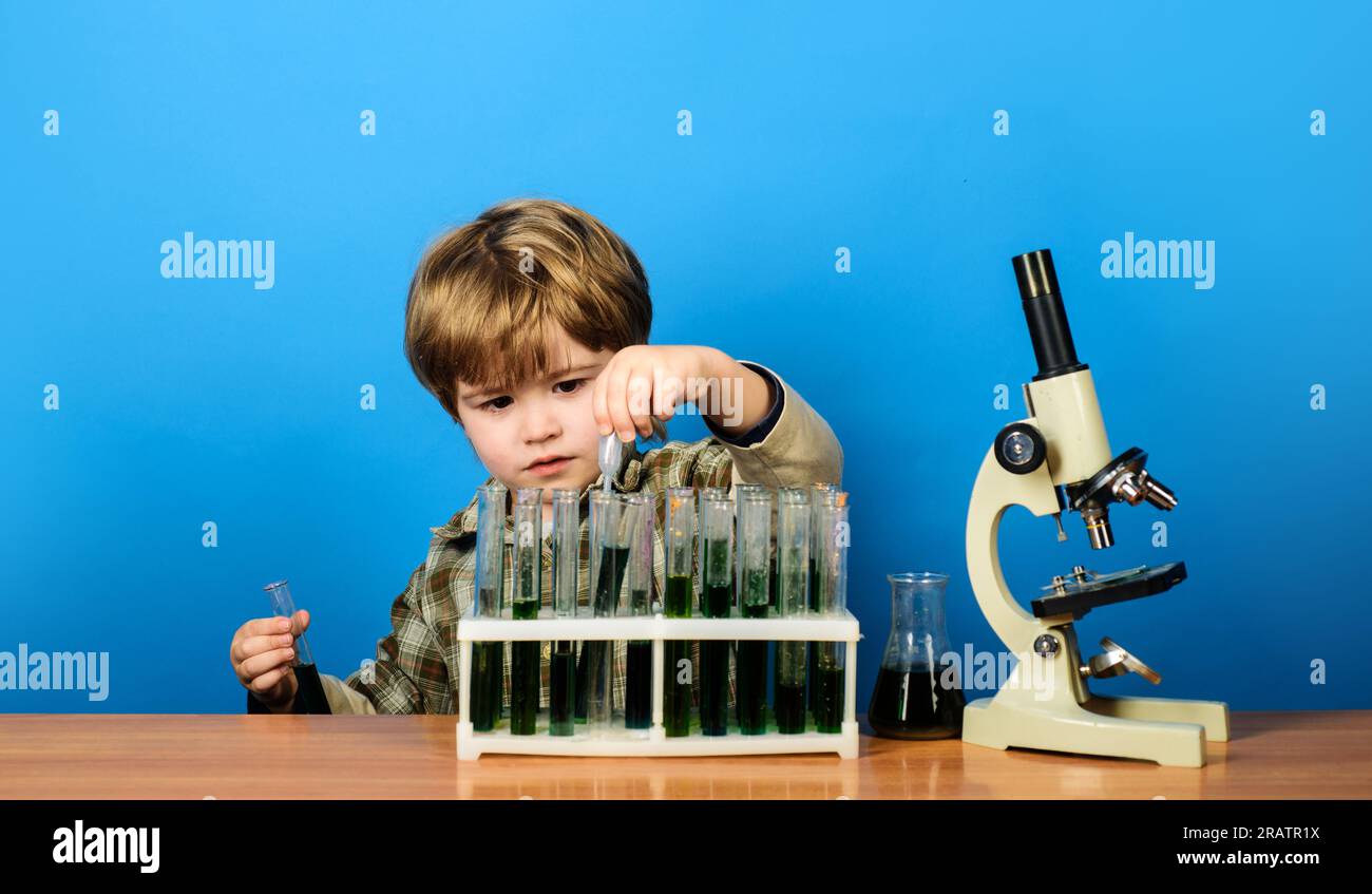 Little boy scientist in laboratory. Educational experiment. Learning chemistry in school lab. Early development of children. Little child working with Stock Photo