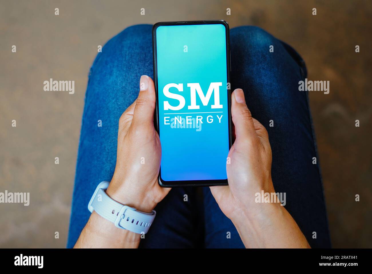 In this photo illustration, the SM Energy Company logo is displayed on a smartphone screen. Stock Photo