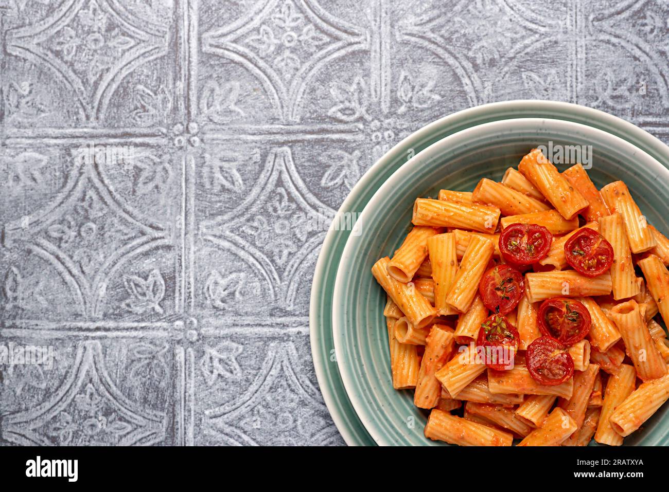 Blank food photography of pasta, rigatoni with  roasted tomatoes, sauce, olive oil, durum, wheat, semolina, background, italian Stock Photo