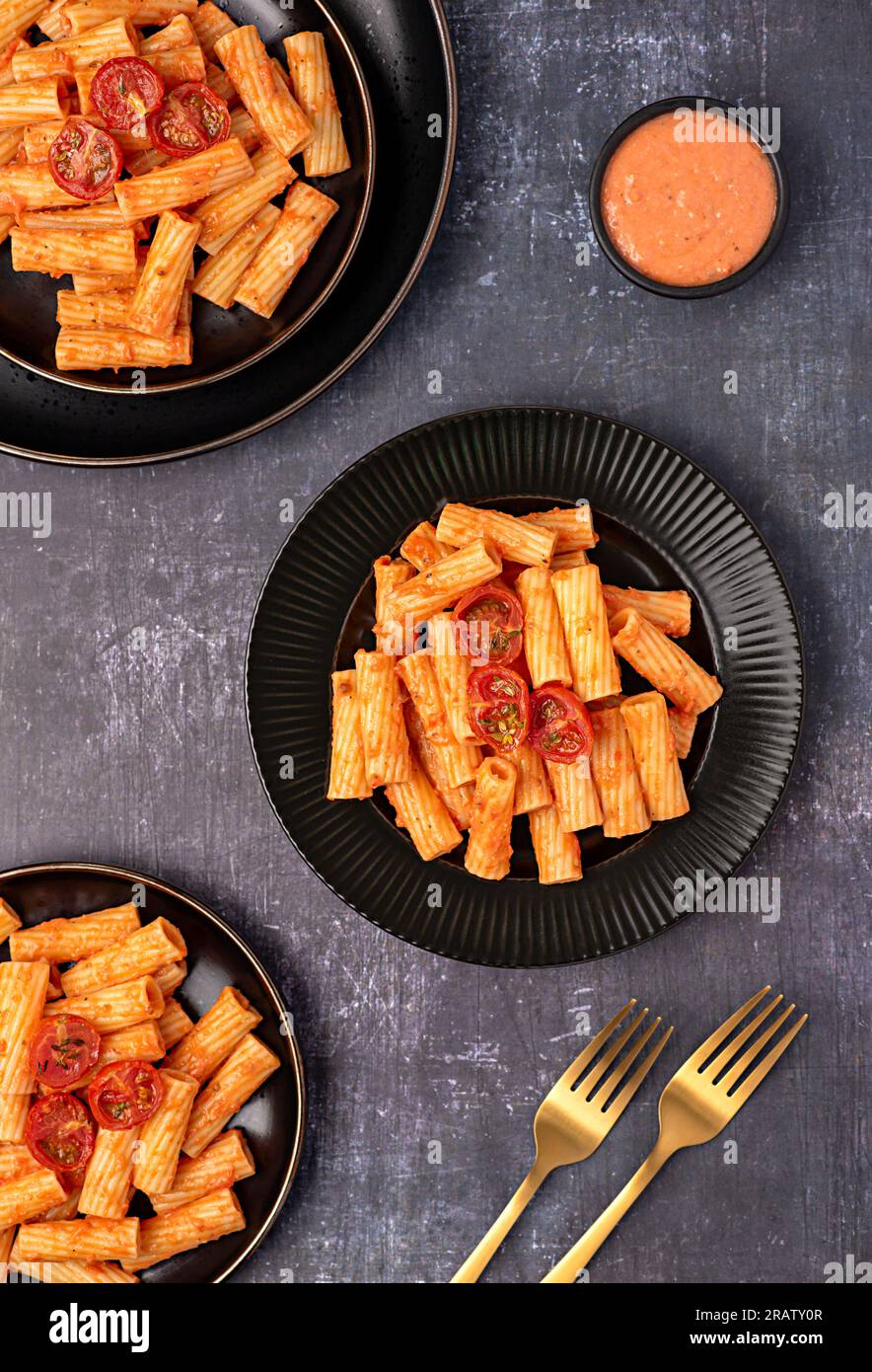 Food photography of pasta, rigatoni with roasted tomatoes, sauce, olive