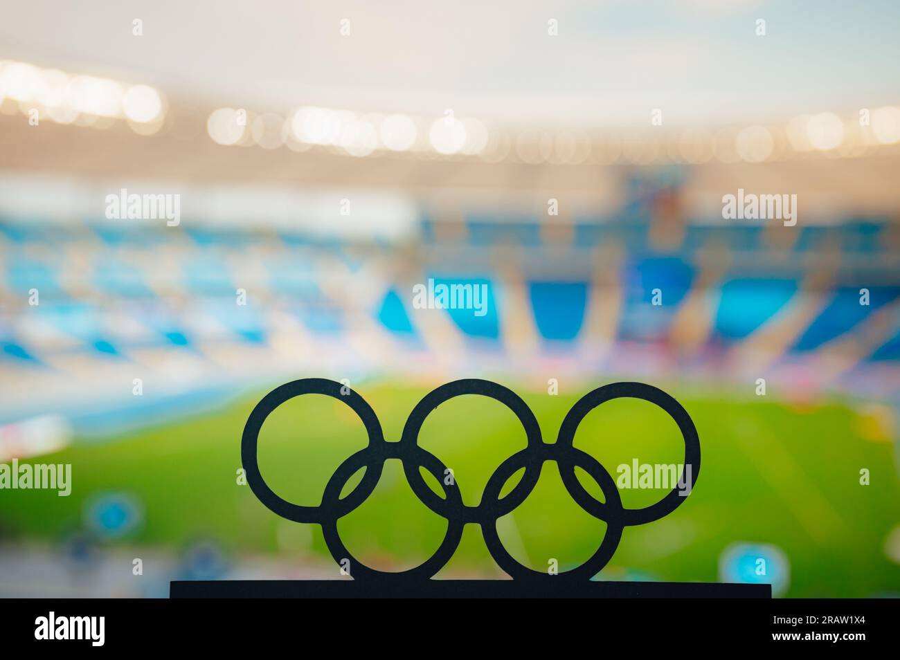 PARIS, FRANCE, JULY 7, 2023: Silhouette of Olympic Rings Reflecting on a Modern Olympic Stadium's Grandeur Stock Photo