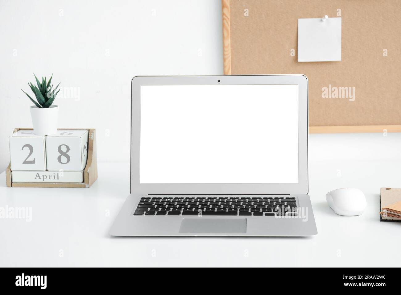 Modern laptop with blank screen on table in office Stock Photo - Alamy