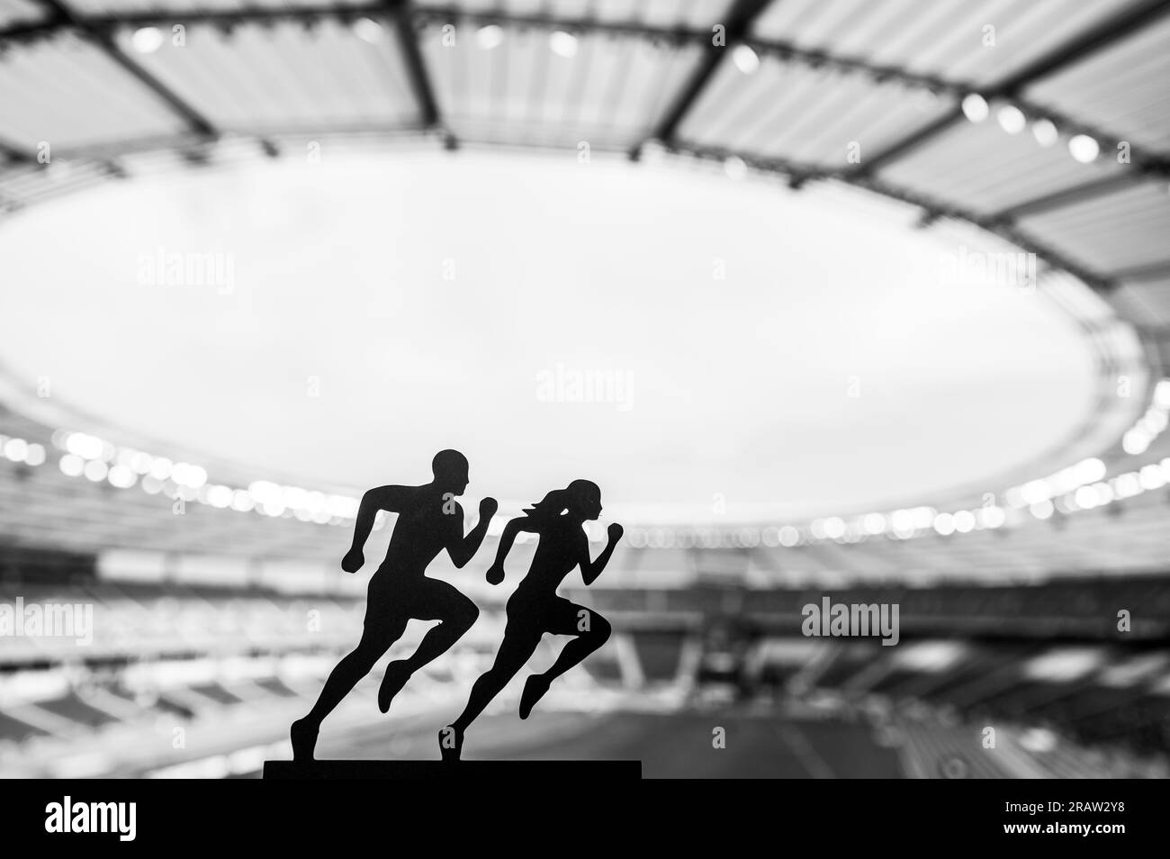 Silhouettes of Male and Female Runners Showcase Dedication and Synergy, Transcending Limits at a Modern Sports Stadium Stock Photo