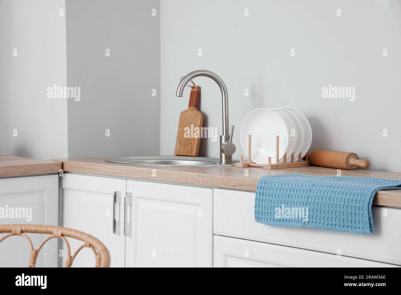 Sink and plate rack on wooden countertop in modern kitchen Stock Photo