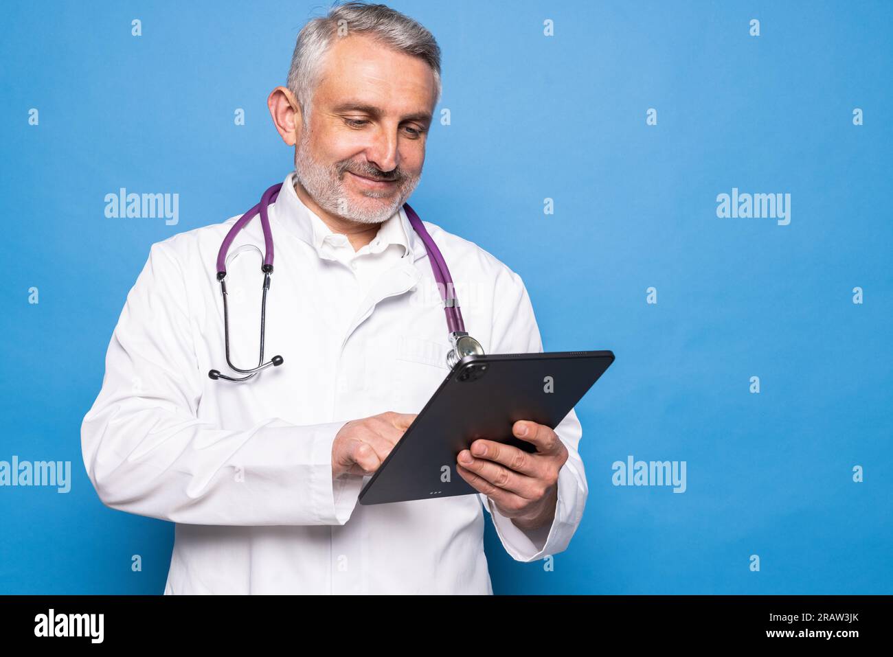 Friendly handsome middle aged man in white robe wearing eyeglasses with ...