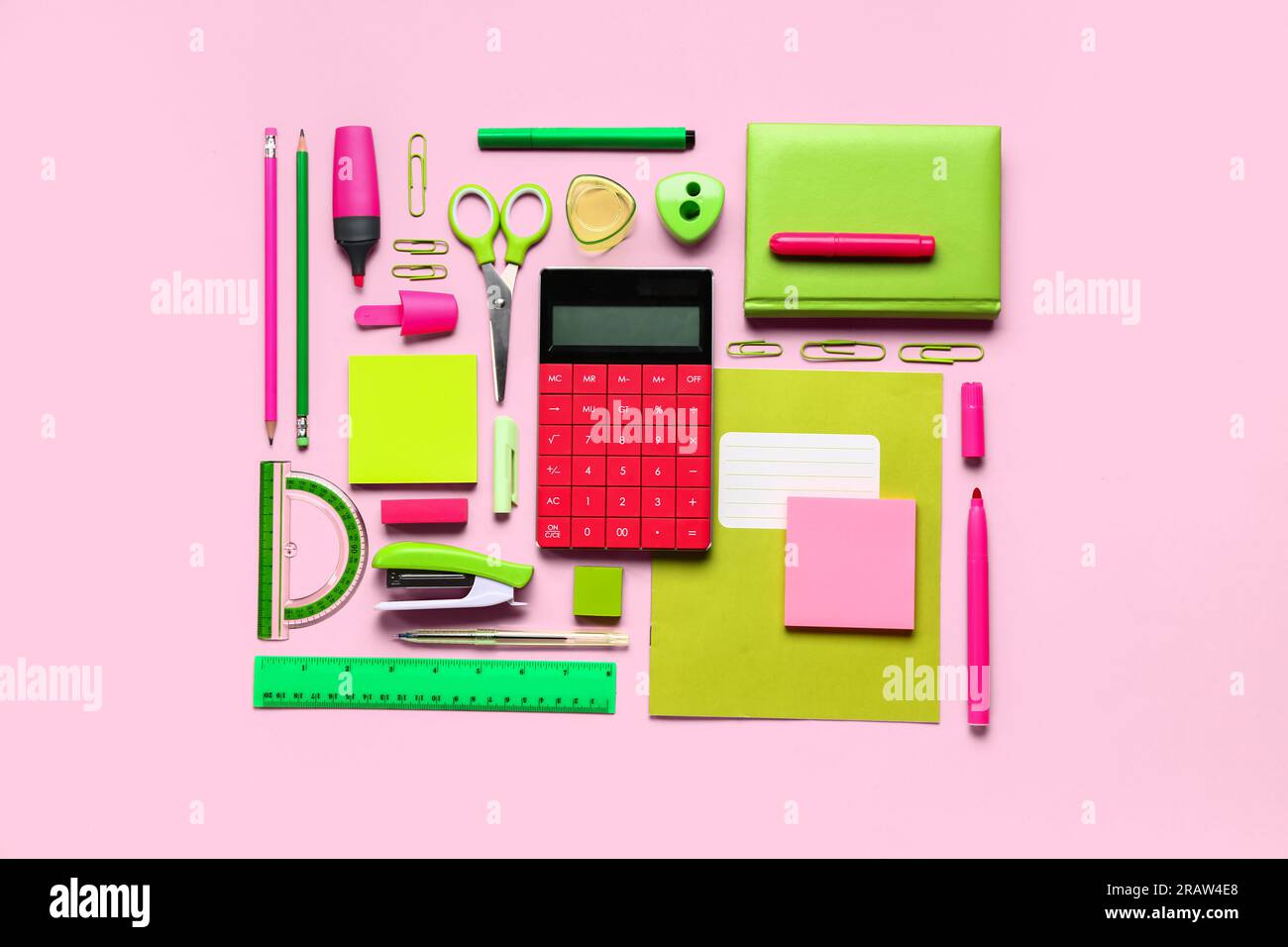 Modern calculator with different stationery on pink background Stock Photo