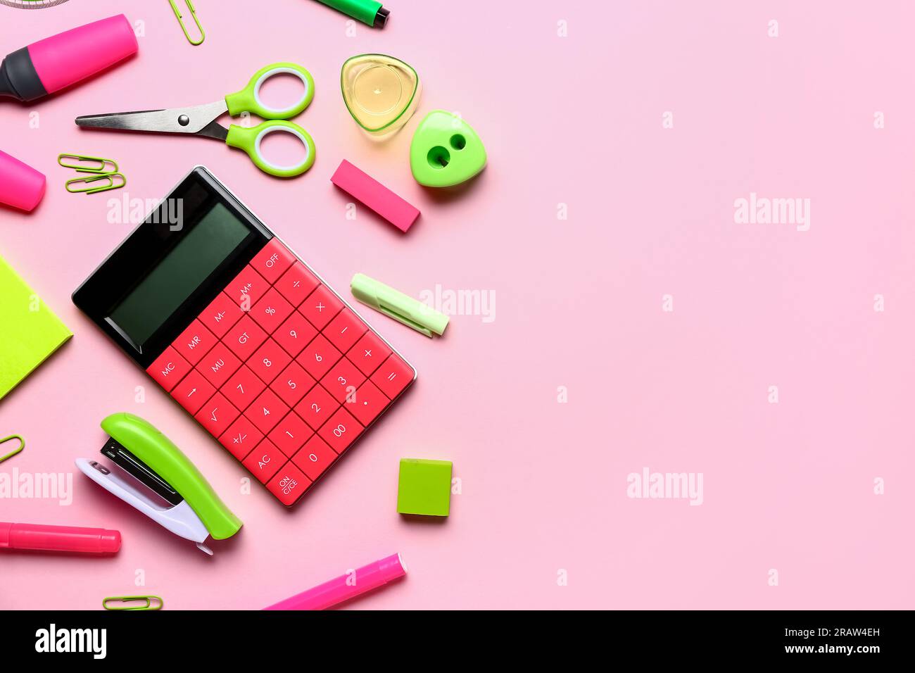 Modern calculator with different stationery on pink background Stock Photo