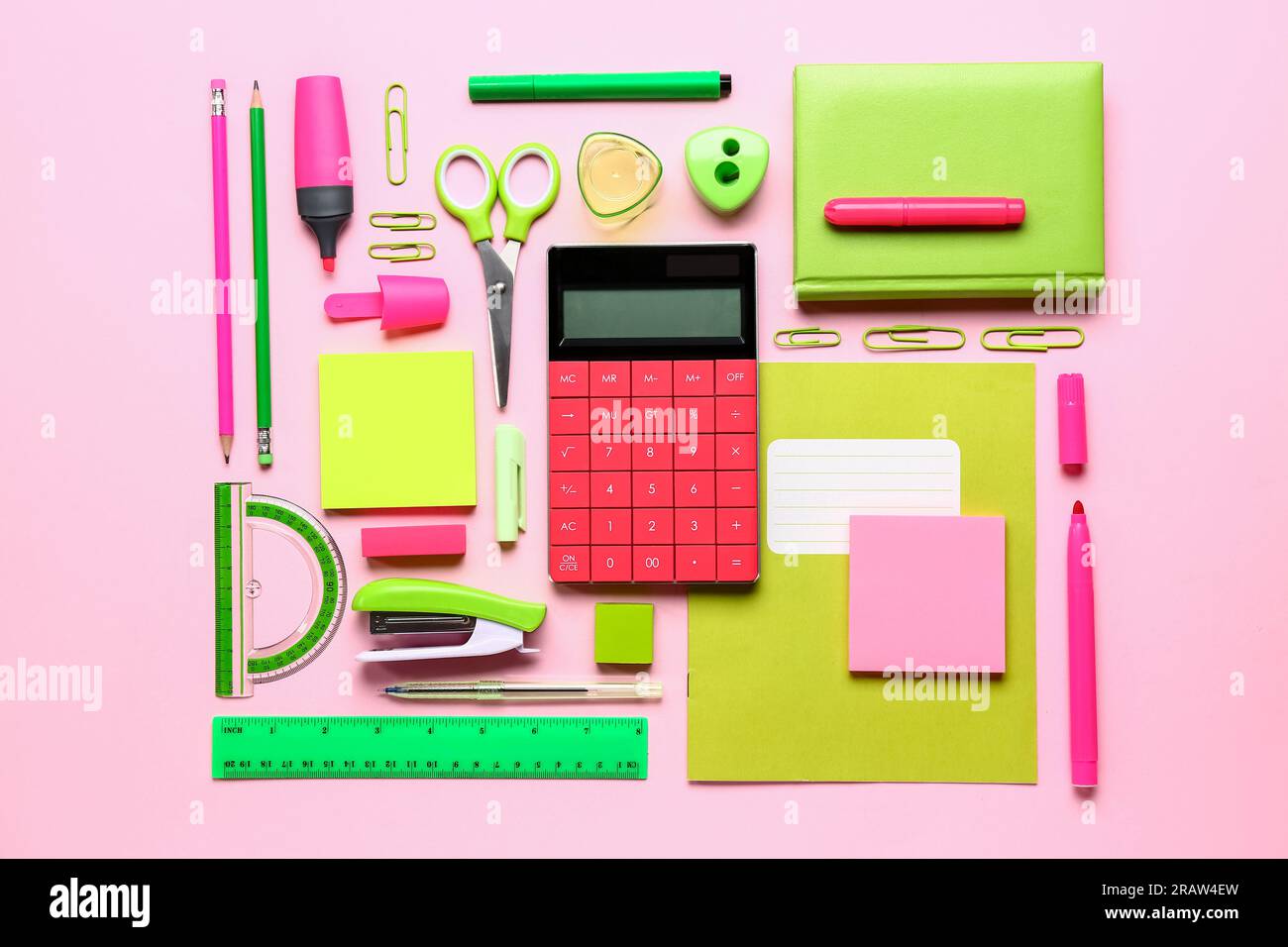 Modern calculator with different stationery on pink background Stock Photo