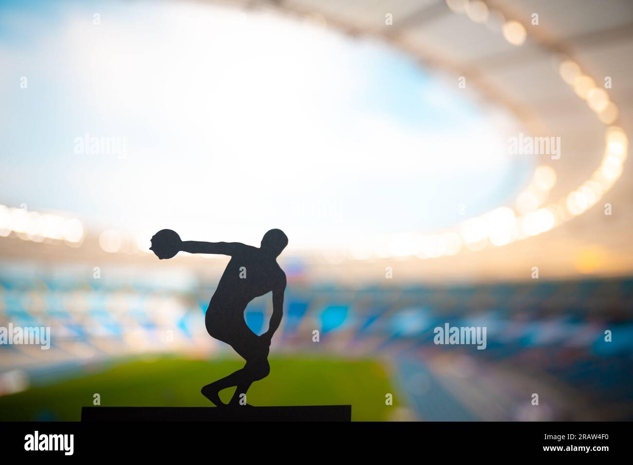 Silhouette of Discus Thrower, Showcasing Technique at Modern Stadium