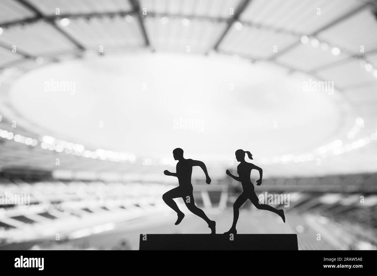 Silhouettes of Male and Female Runners Create a Mesmerizing Display of Teamwork at a Modern Sports Stadium. Shared Passion, Black and White Photo Stock Photo
