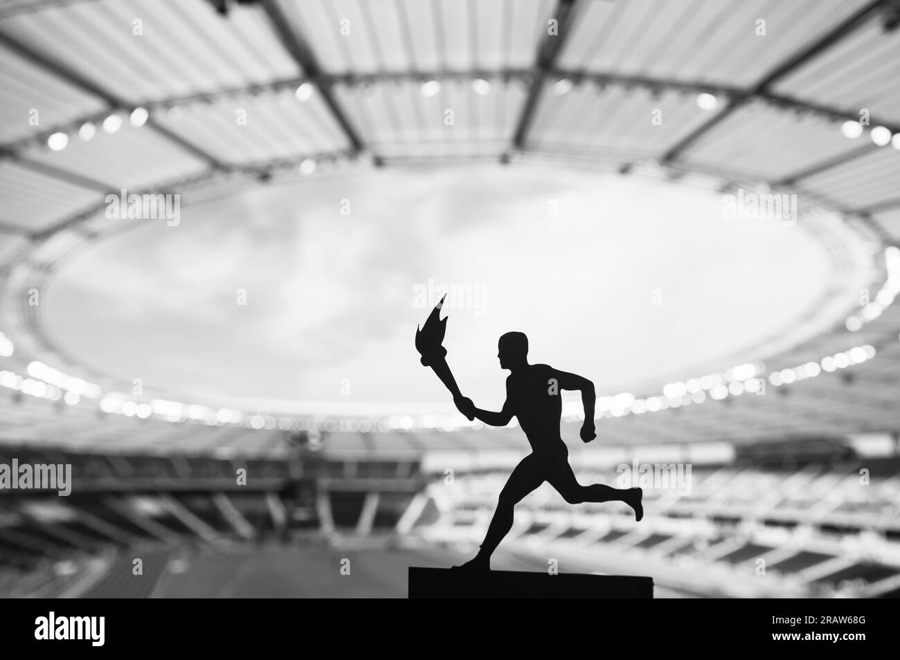 Silhouette of Male Athlete Carrying the Torch Relay, Illuminating the