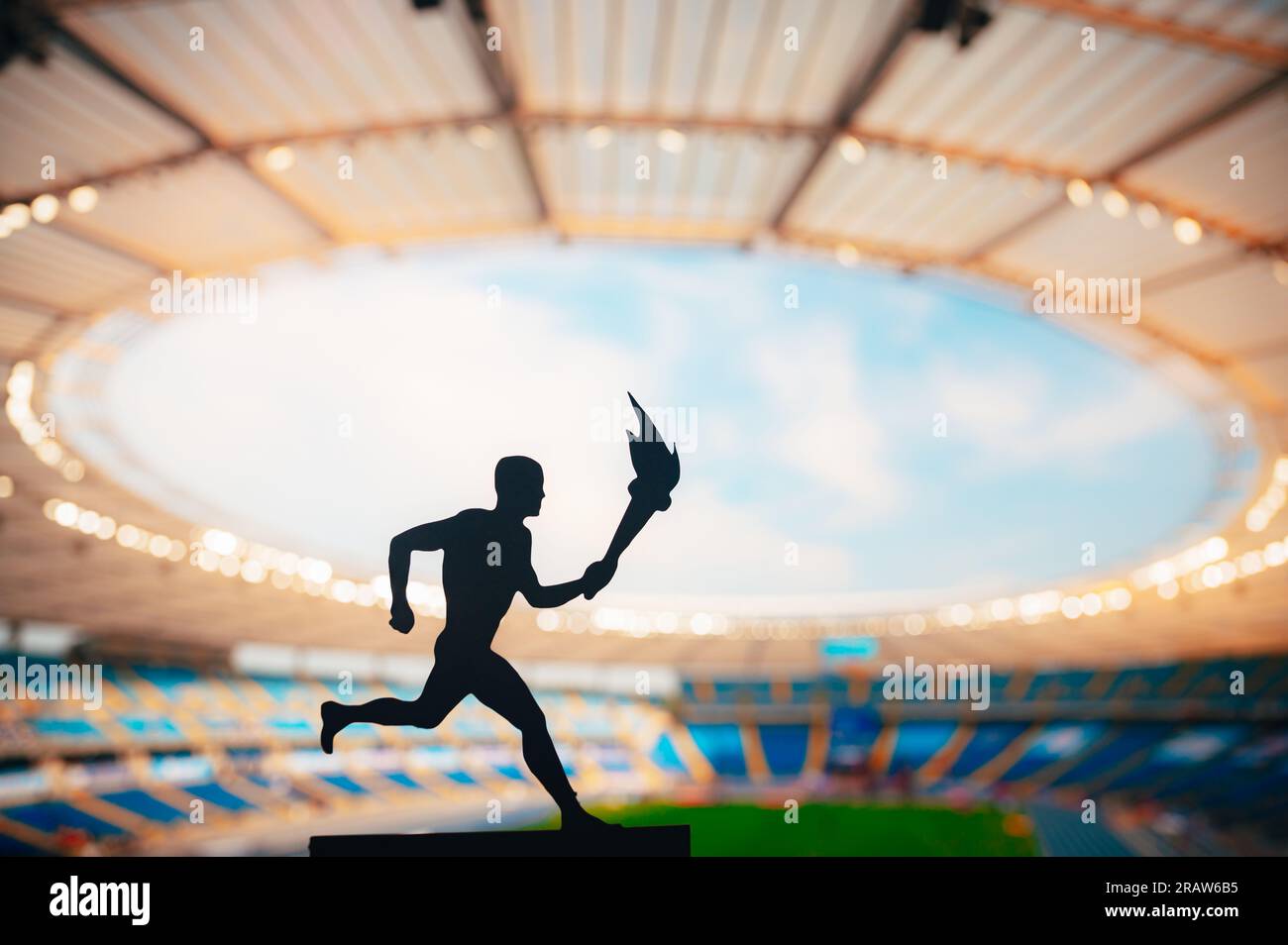 Silhouette of Male Athlete Carrying the Torch Relay, Illuminating the