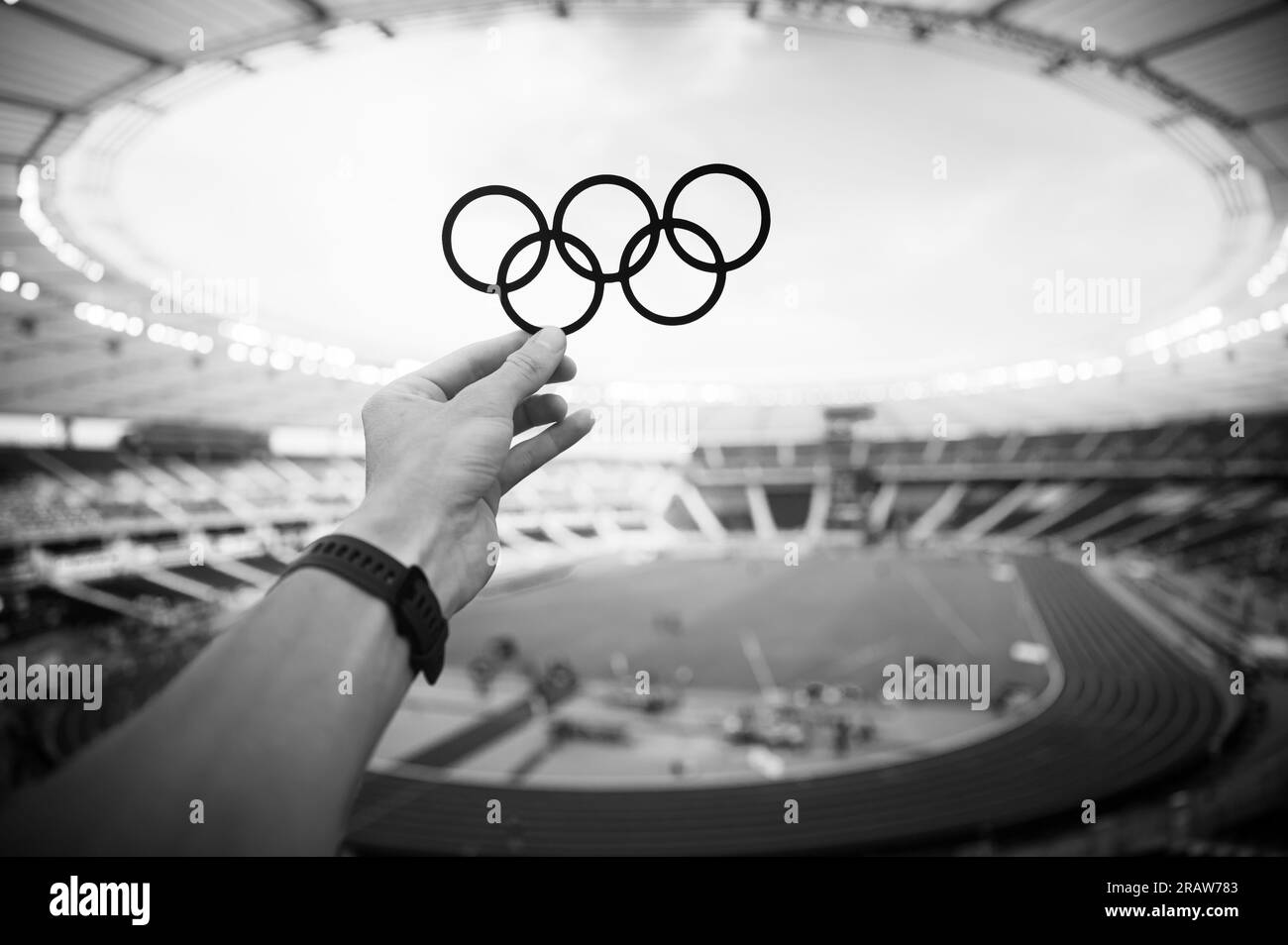 PARIS, FRANCE, JULY 7, 2023: Athlete Holds Olympic Rings Symbol with Pride. Photo for Summer Olympic Games in Paris 2024. Stock Photo