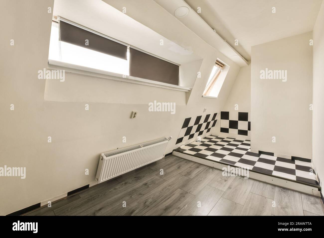 an empty room with black and white checkered tiles on the floor, in ...