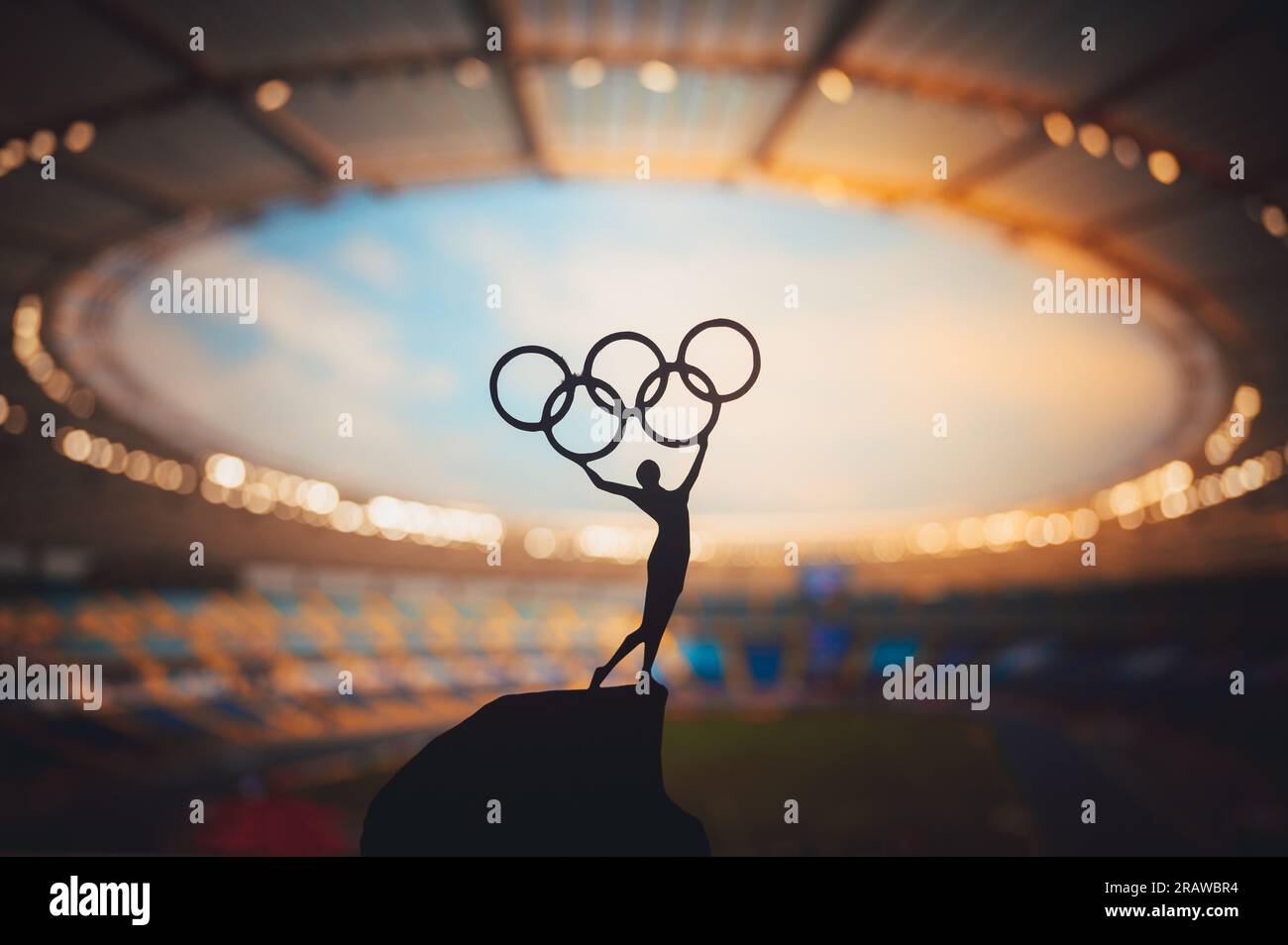 PARIS, FRANCE, JULY 7, 2023: Black and White Photo. Olympic Spirit: Statue of Athlete Holds Olympic Circle High at Modern Olympic Stadium. Capturing t Stock Photo