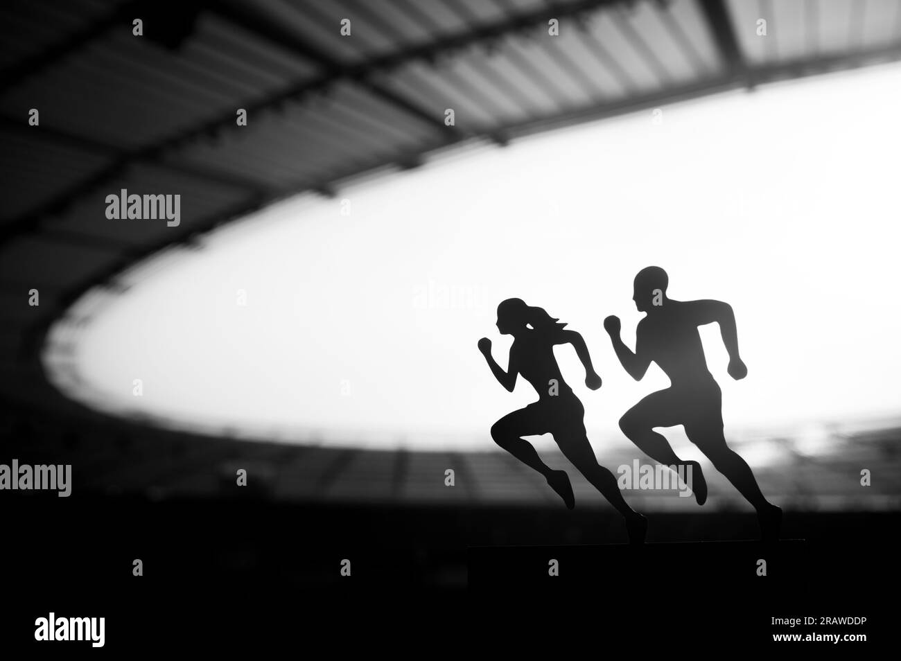 Silhouettes of Male and Female Runners Showcase Dedication and Synergy, Transcending Limits at a Modern Sports Stadium. Black and White photo Stock Photo