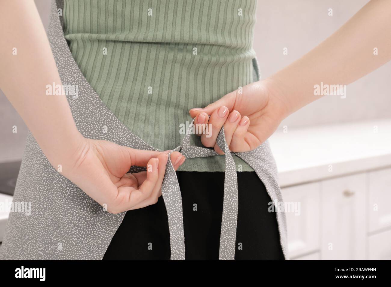 Putting on apron hi-res stock photography and images - Alamy
