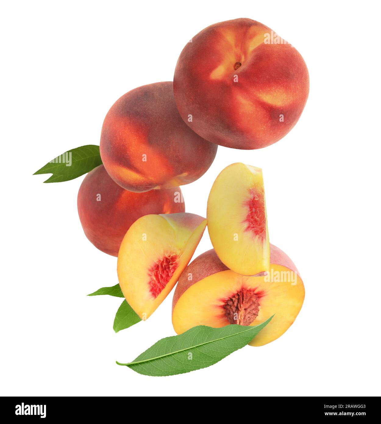 Cut and whole fresh ripe peaches with green leaves falling on white ...