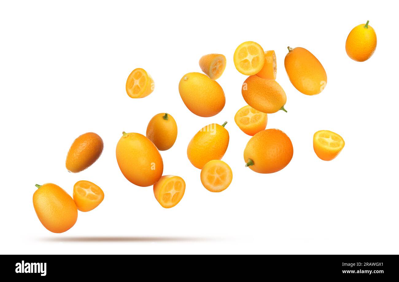 Delicious whole and cut kumquats falling on white background Stock