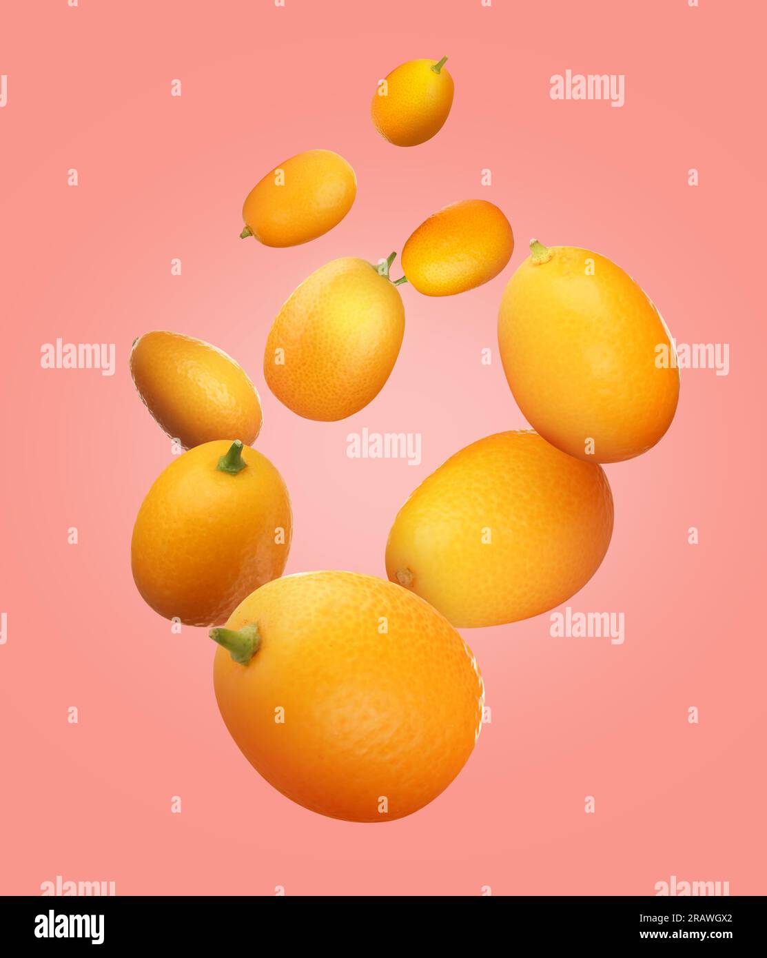 Delicious fresh kumquats falling on pink background Stock Photo Alamy
