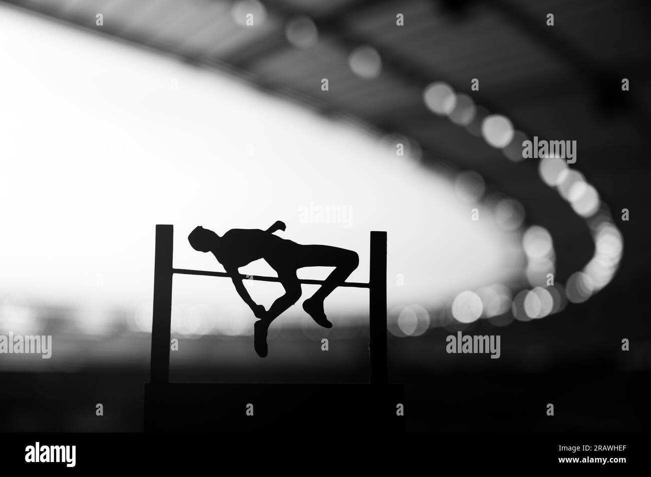 Silhouette of High Jumper Ascending Amidst Evening Radiance. Black and White Photo for Summer Games 2024 in Paris. Edit Space for Your Montage Stock Photo