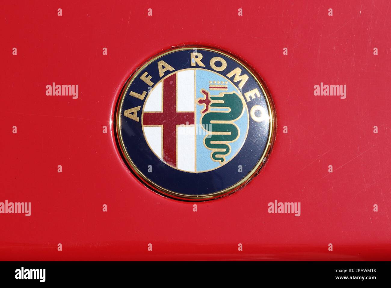 Alfa Romeo six coloured automotive badge fitted to cars made from 1982 through to 2014, captured here fitted to the boot lid of an Alfa Romeo 33 model. Stock Photo