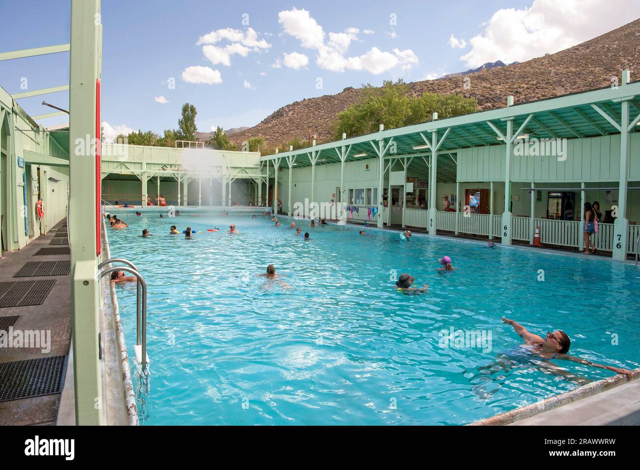 People enjoying the hot mineral water in a pool at Keough Hot Springs built in 1918 near Bishop, California, USA Stock Photo