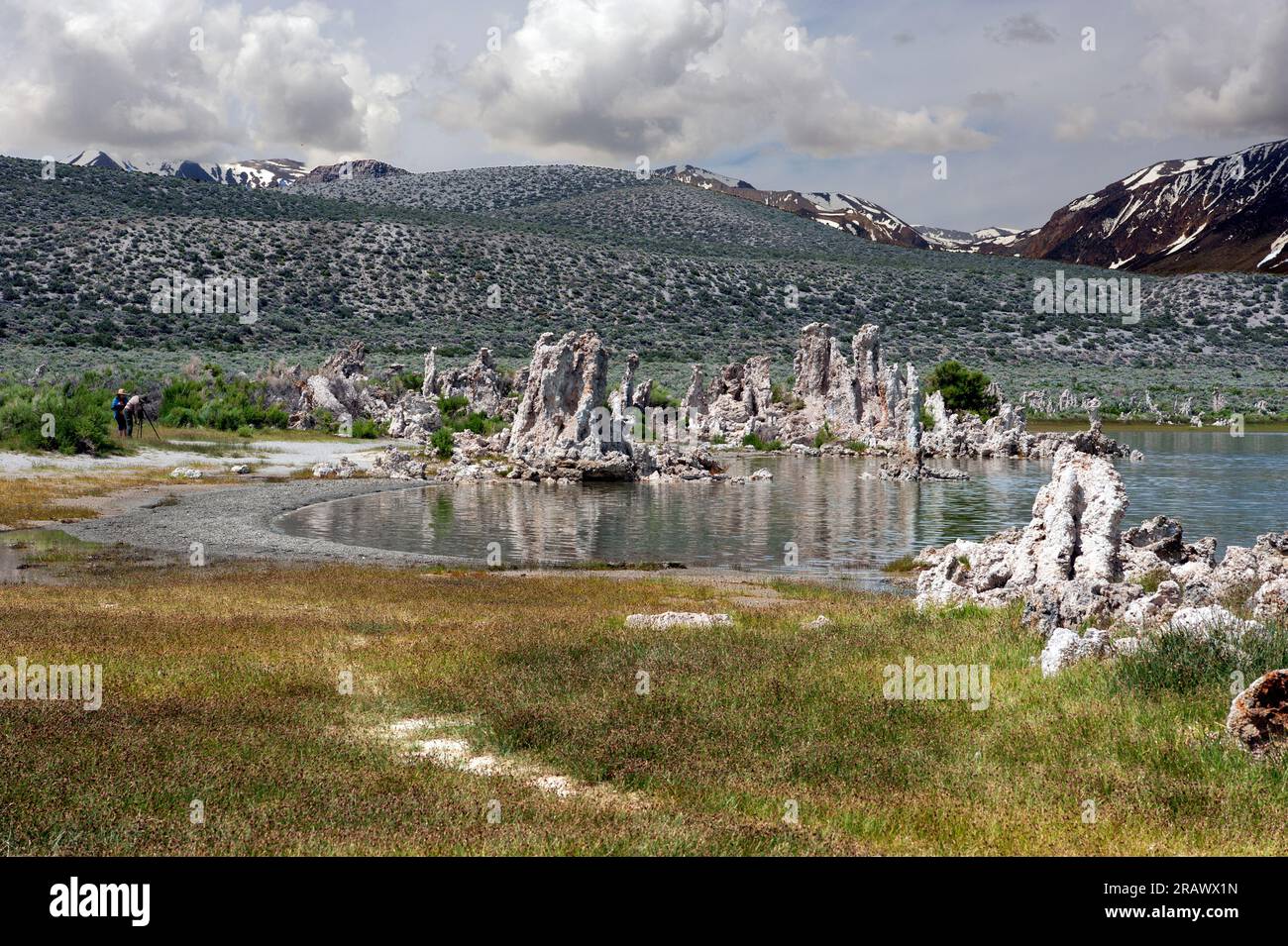 Tufas and receding water with Sierra Nevada mountains in background at Mono Lake, California, USA Stock Photo