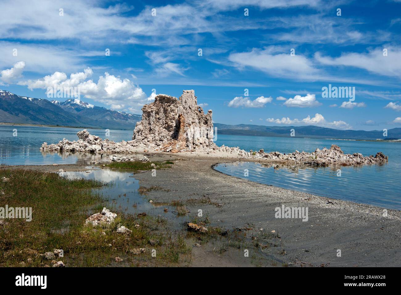 Tufas and receding water with Sierra Nevada mountains in background at Mono Lake, California, USA Stock Photo