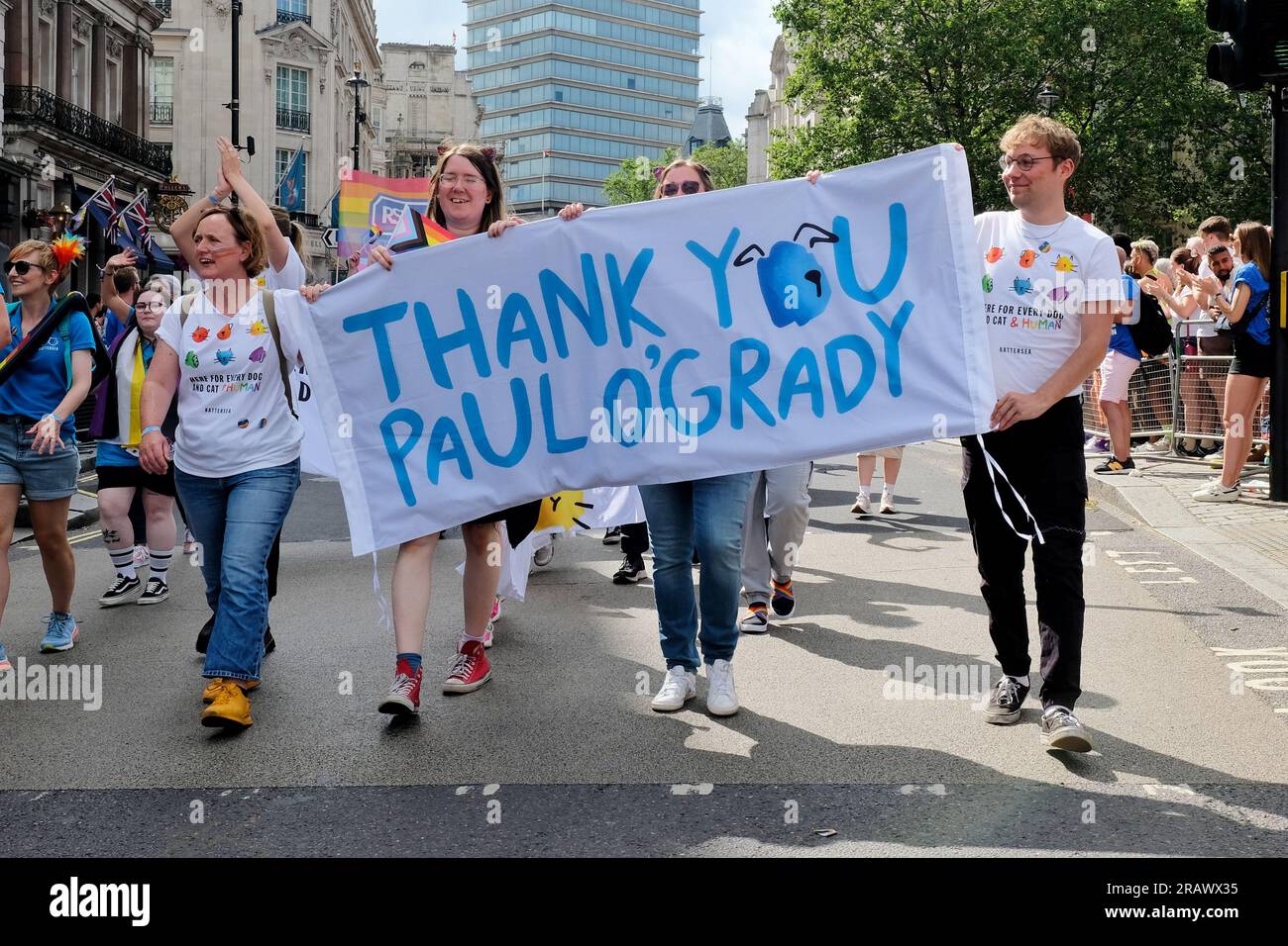 London, UK. Pride in London Parade marchers representing Battersea Cats and Dogs Home thank Paul O'Grady for his long term support. Stock Photo