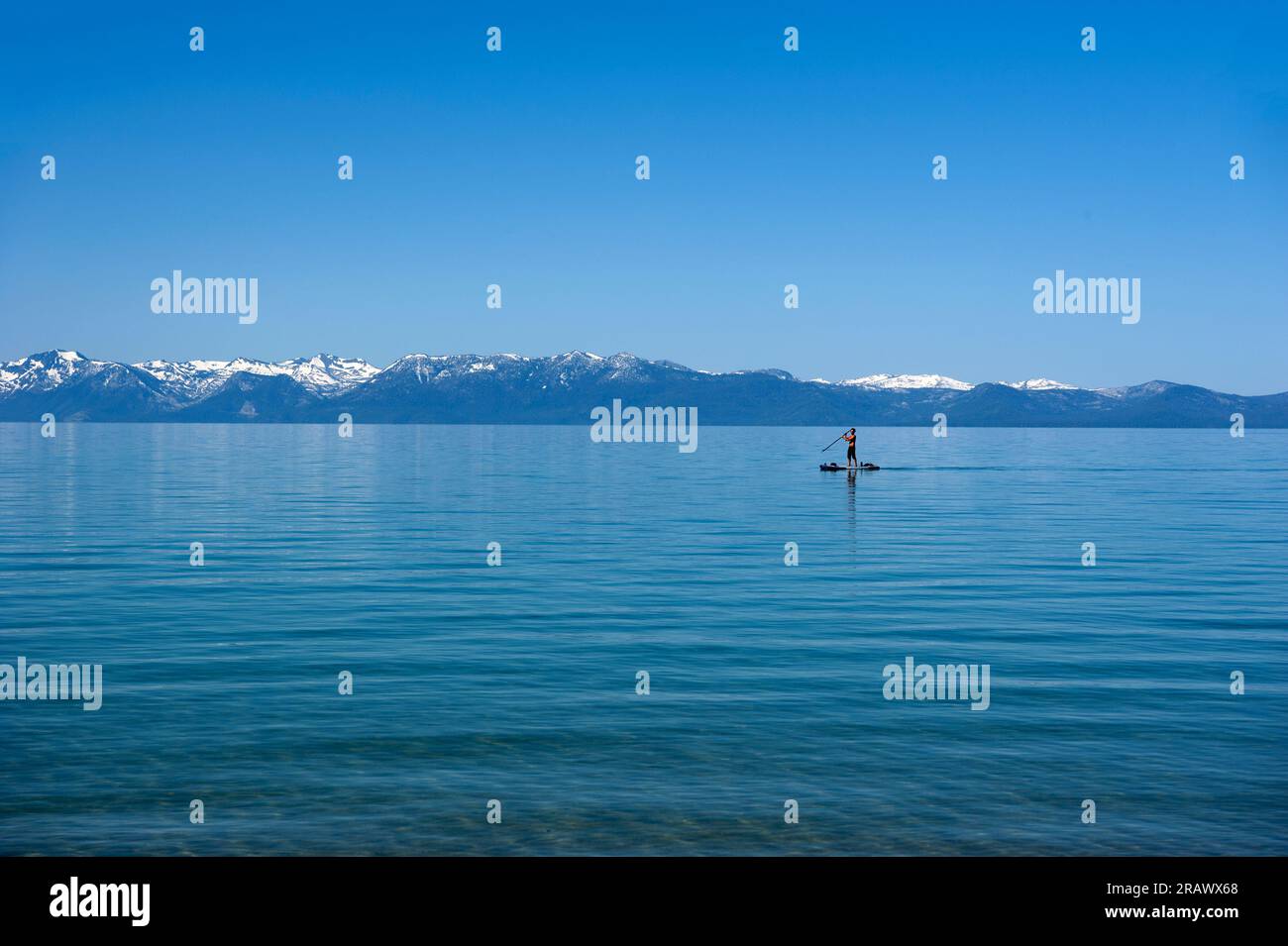 A man on a paddle board at Sand Harbor in Lake Tahoe, California Stock Photo