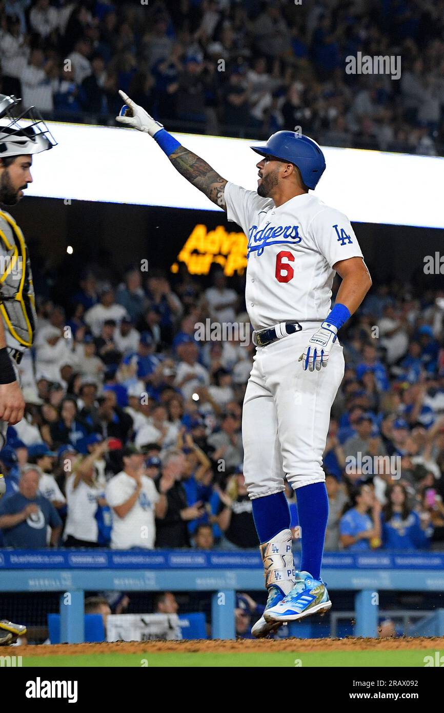 Los Angeles Dodgers' David Peralta, right, gestures to fans as he scores  after hitting a solo home run while Pittsburgh Pirates catcher Austin  Hedges stands by during the fifth inning of a