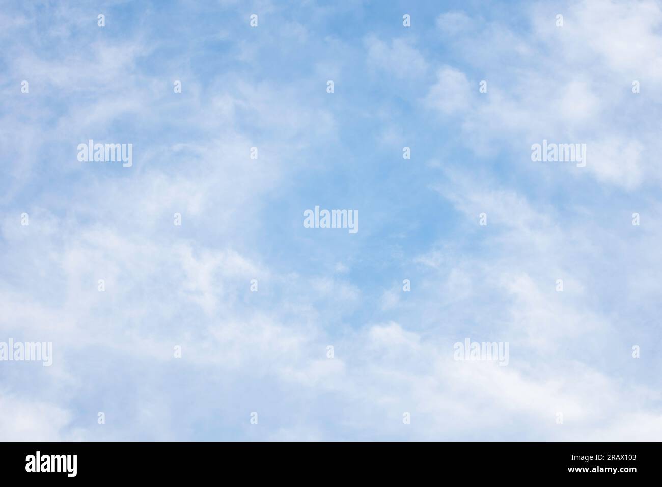 Background of diffused cirrocumulus clouds against a blue sky. Stock Photo
