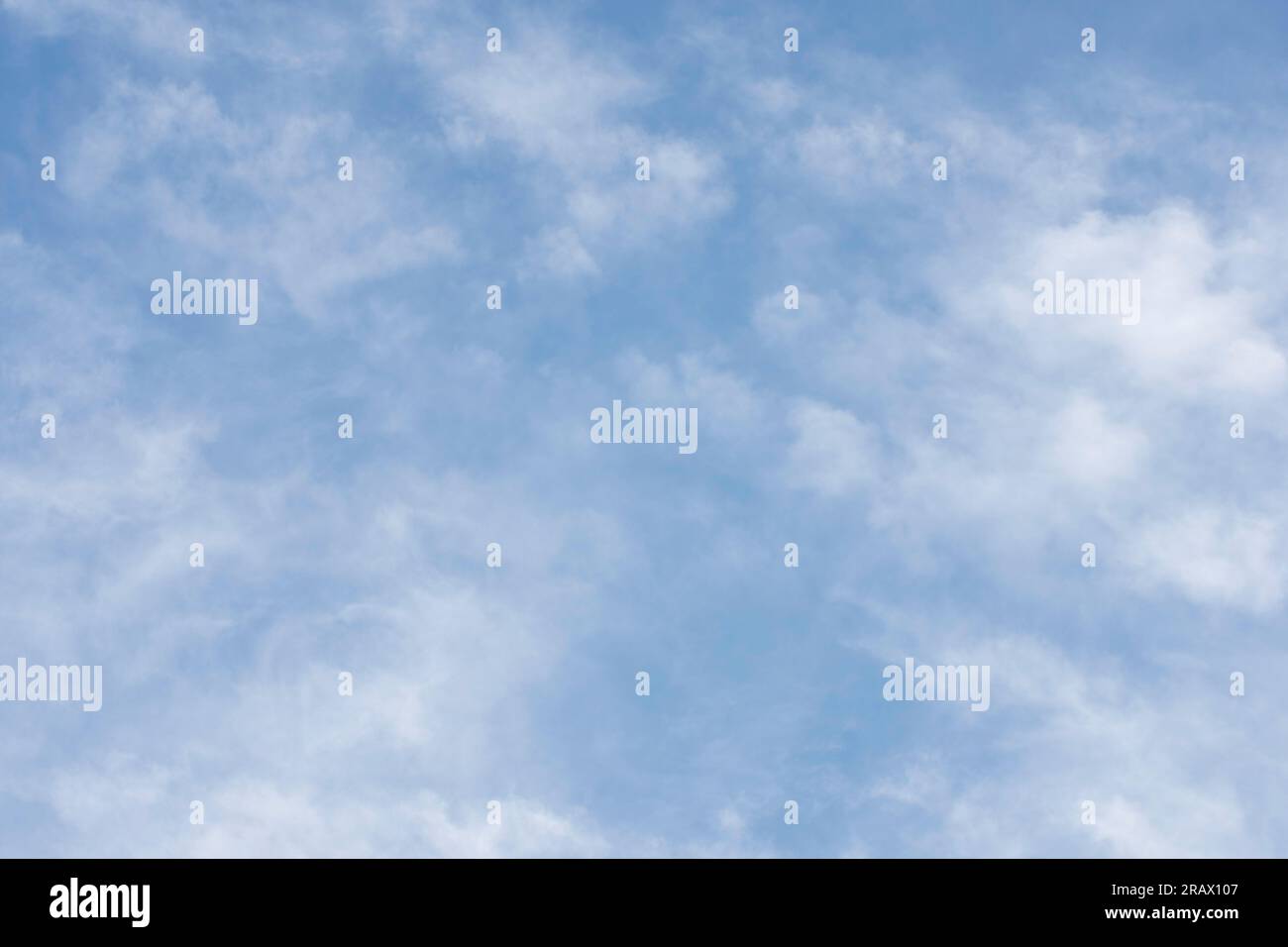Sky background of cirrocumulus clouds visible in late afternoon against a blue sky. Stock Photo