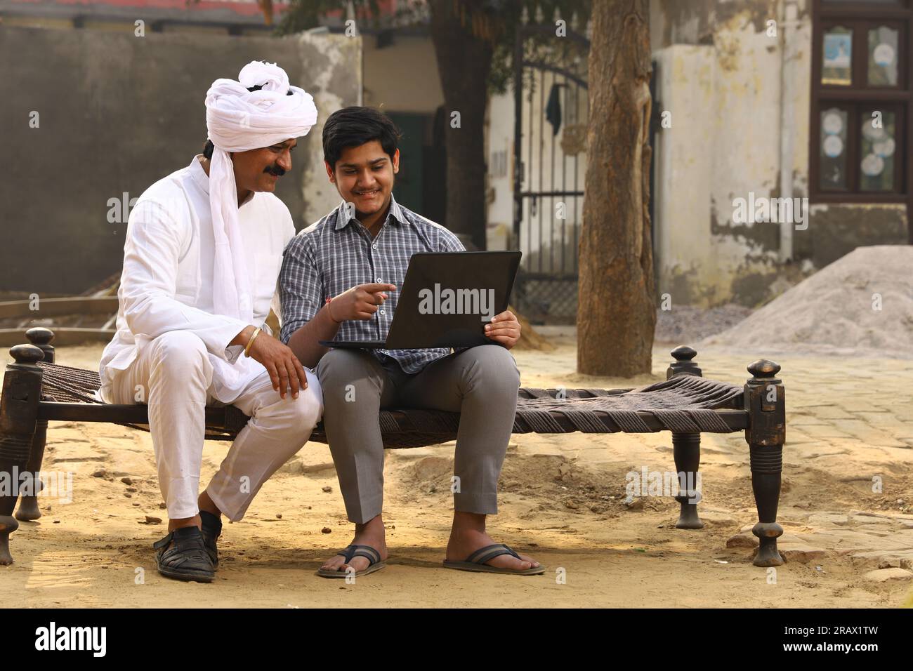 Happy rural Indian family in village Aspirational family sitting with a