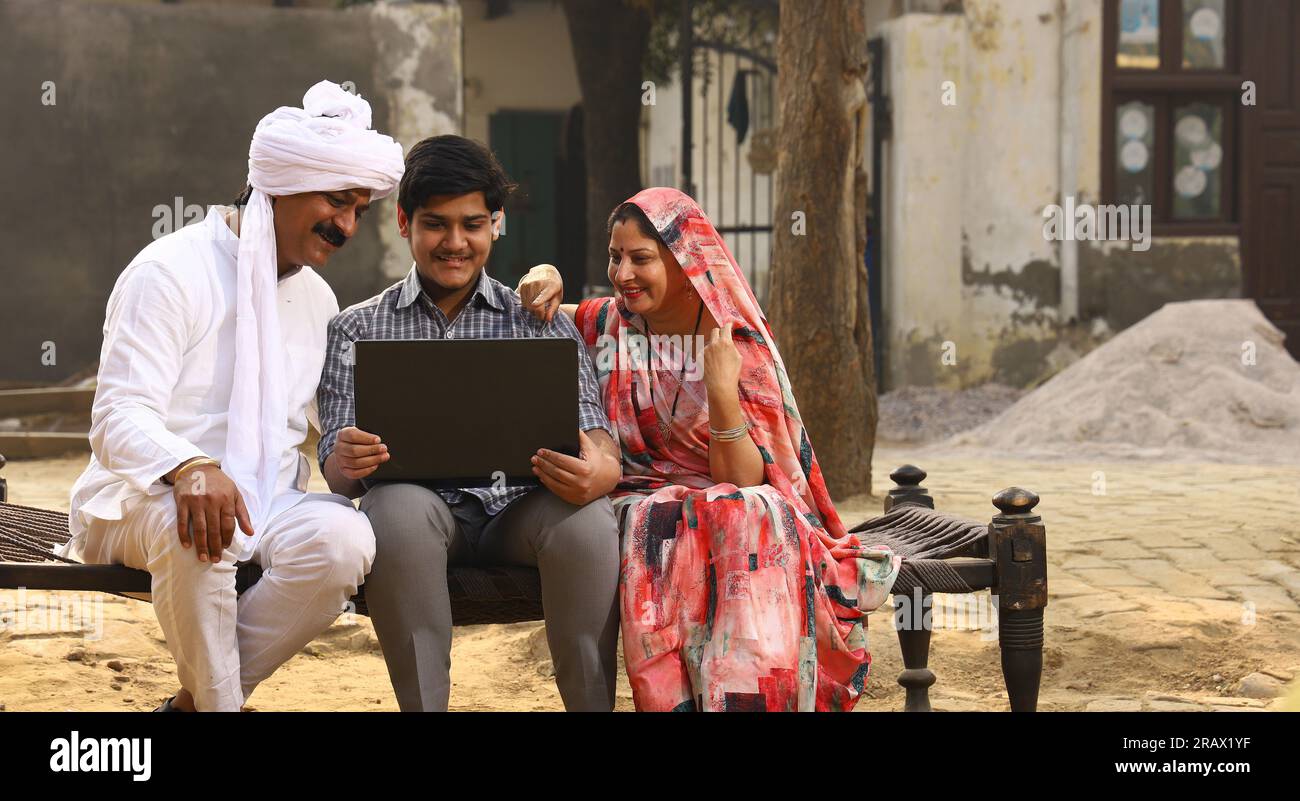 Happy rural Indian family in village Aspirational family sitting with a