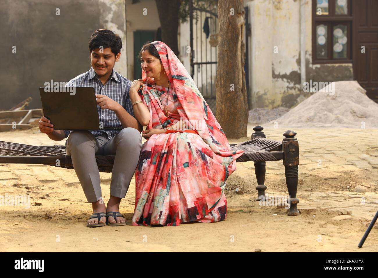 Happy rural Indian family in village Aspirational family sitting with a