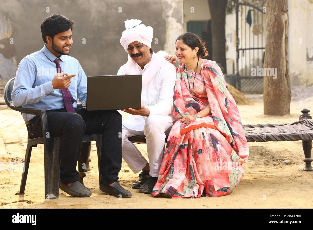 Happy rural Indian family in village Aspirational family sitting with a