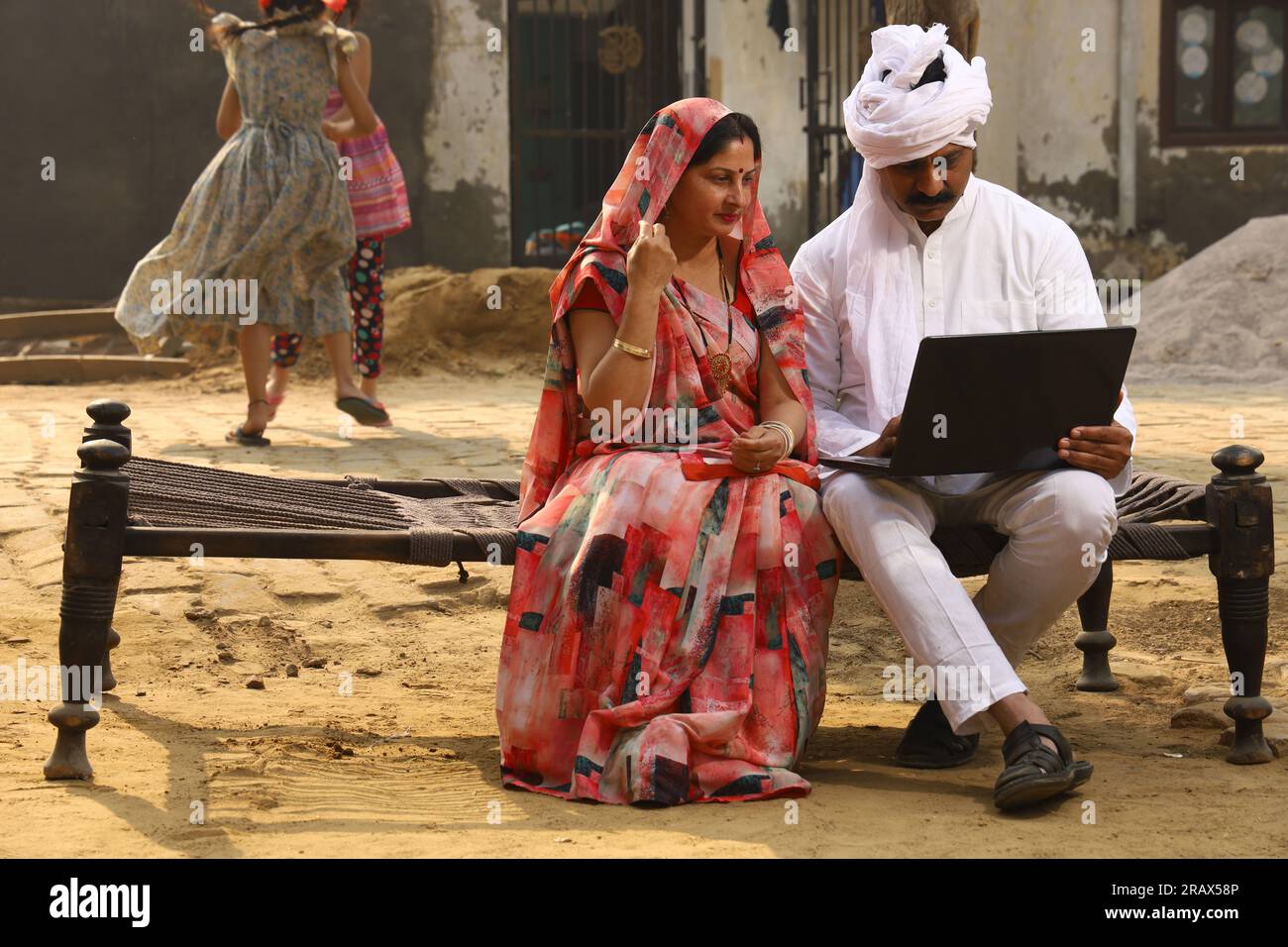 Happy Indian Rural family in village. Rural couple sitting together ...