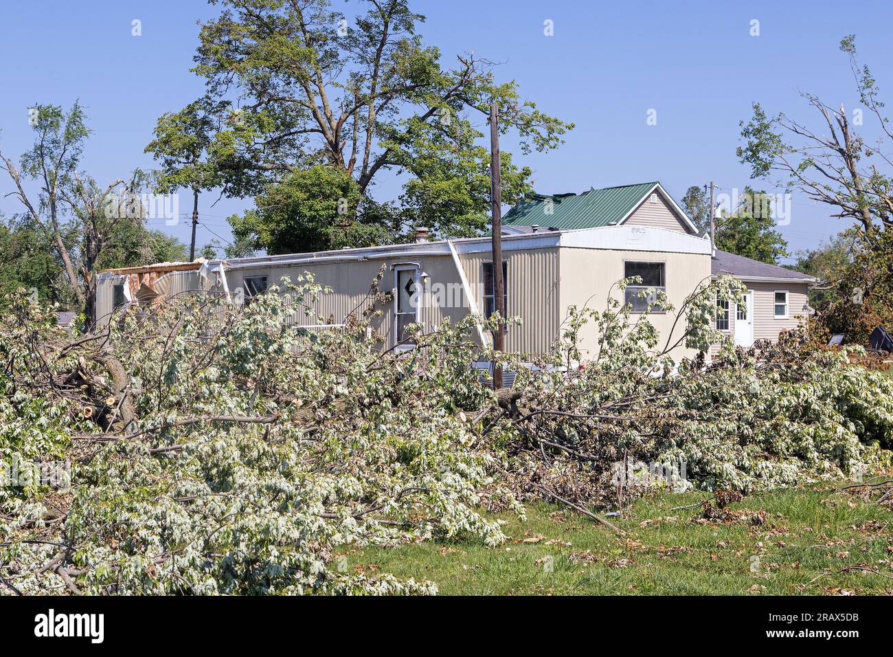 During the 4th of July holiday in La Harpe, Illinois, residents cleaned up the extensive damage done by a derecho storm that struck the area on 29th J Stock Photo