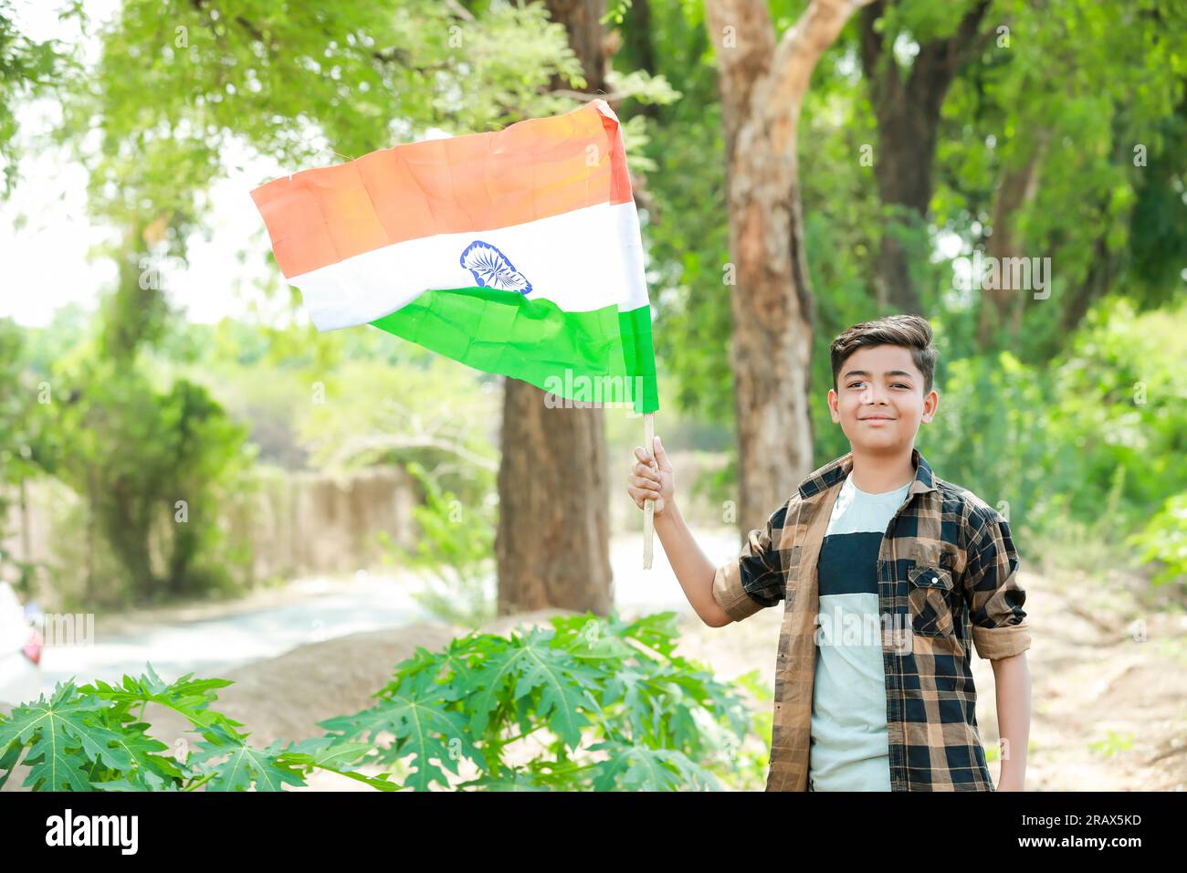 Indian boy holding national flag in farm, happy boy, national flag