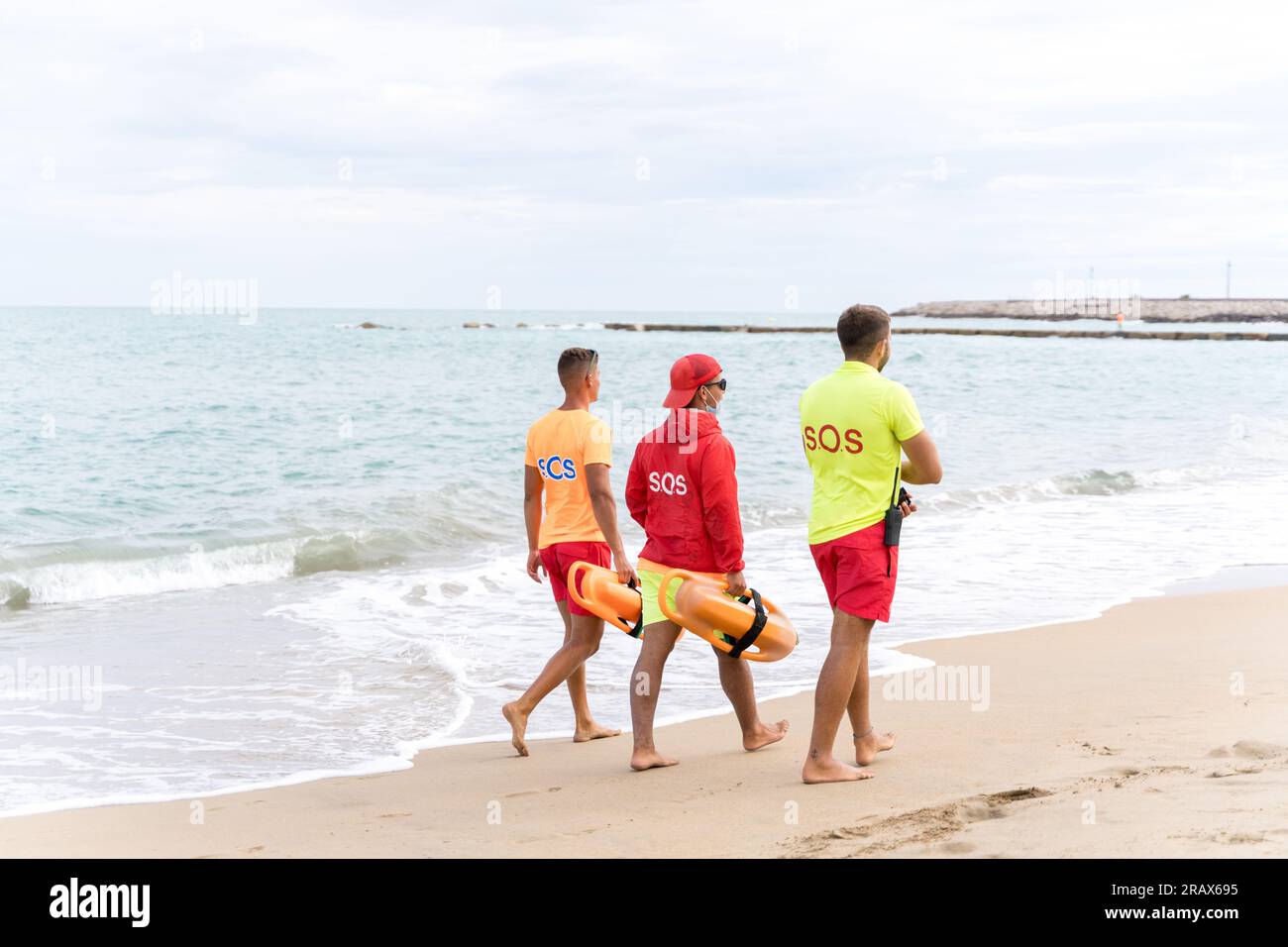 Photo with copy space of three rescue lifeguards on duty on a beach
